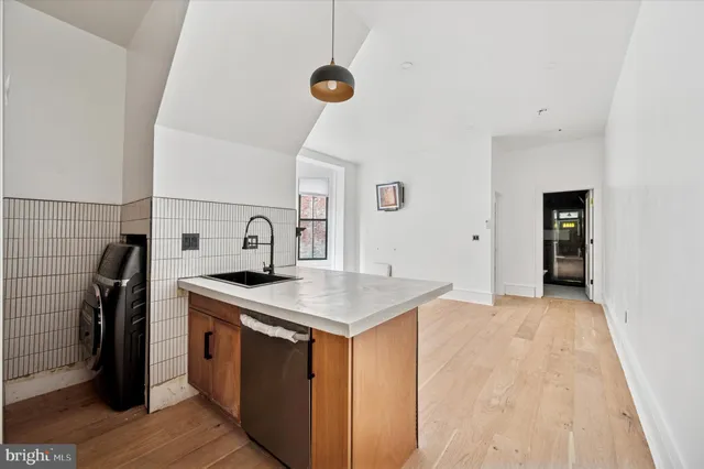 a kitchen with a sink a refrigerator and a stove