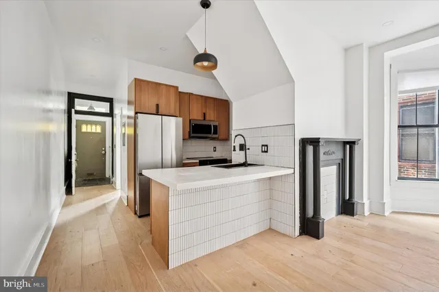a kitchen with stainless steel appliances a refrigerator and a stove