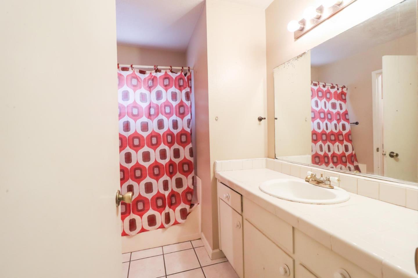1725 East Rumble Road Modesto, CA 95355 - Photo 30 of 31 a bathroom with a sink and a mirror