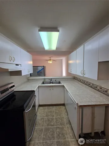 a kitchen with a sink stove and cabinets