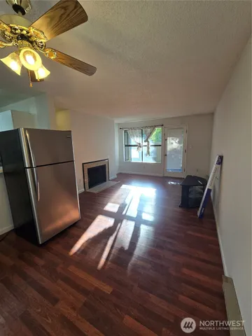 a view of a livingroom with wooden floor and staircase