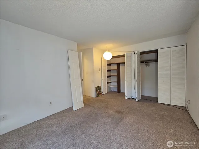 a view of empty room with closet