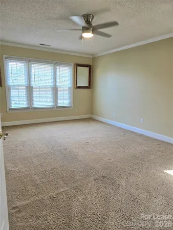 an empty room with a empty space and windows
