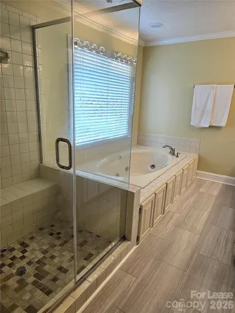 a bathroom with a tub and shower