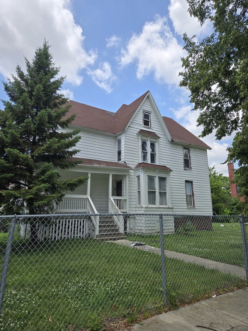 738 West 87th Street Chicago, IL 60620 - Photo 3 of 3 a front view of a house with a yard
