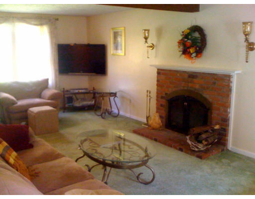 1 Scribner Road Tyngsborough, MA 01879 - Photo 7 of 13 a living room with furniture and a fireplace