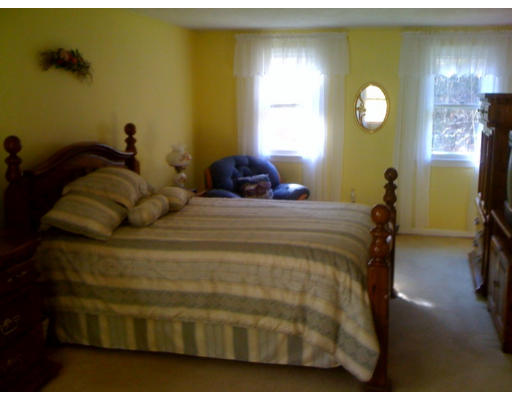 1 Scribner Road Tyngsborough, MA 01879 - Photo 9 of 13 a bedroom with a bed and a chandelier