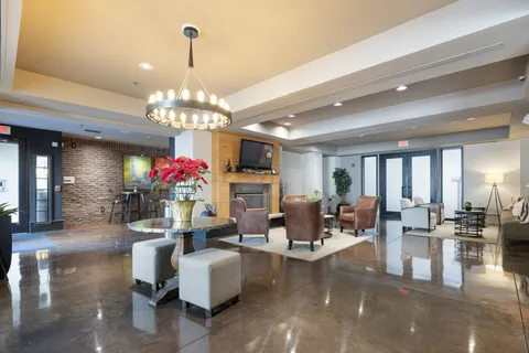 a living room with fireplace furniture and a chandelier