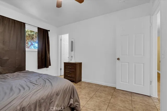 a bedroom with a bed and dresser with mirror