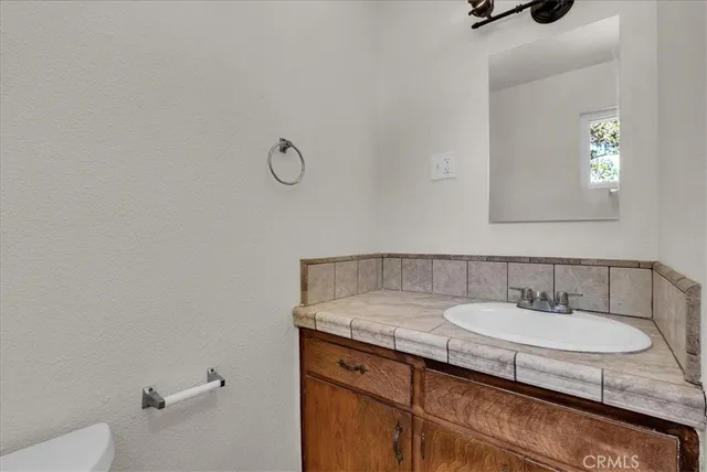a view of a house with backyard and a tree