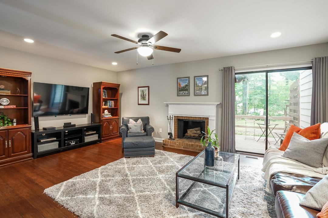 Huge room with new recessed lighting and overhead fan with light. Wood burning fireplace with decorative mantle and brick hearth. Living Room