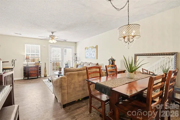 a kitchen with stainless steel appliances granite countertop sink microwave dining table and chairs