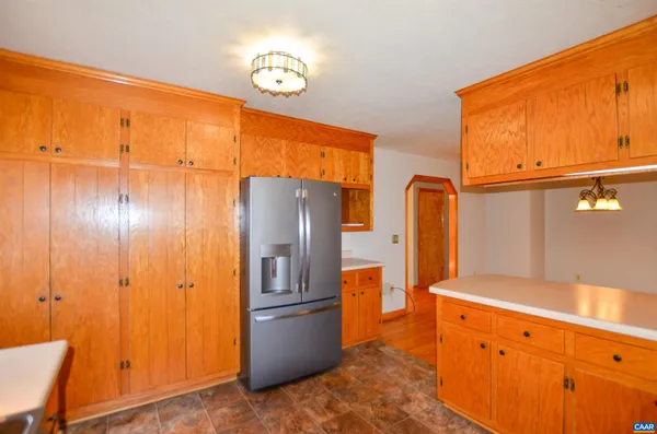 a kitchen with stainless steel appliances granite countertop a refrigerator a stove and a sink with granite countertops