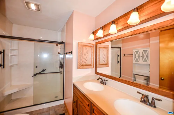 a bathroom with a double vanity sink and mirror