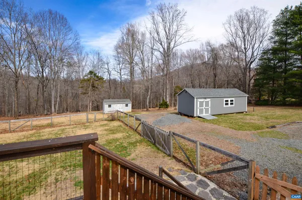 a view of a house with a yard covered with snow