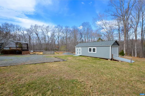 a view of a yard with a house and a tree