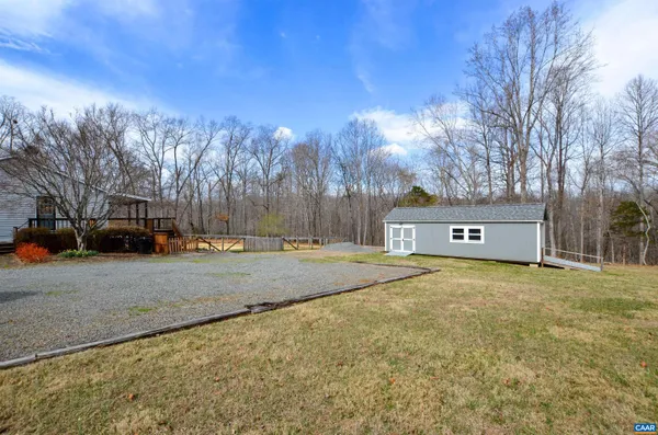 a front view of house with yard covered in snow