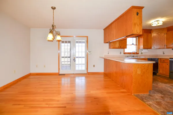 a view of a kitchen with a sink cabinets and a wooden floor