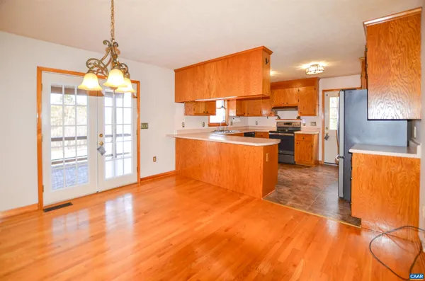 a kitchen with stainless steel appliances granite countertop a sink cabinets and wooden floor