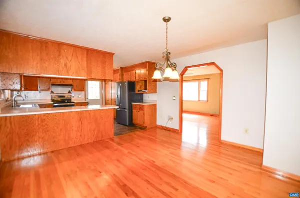 a view of a kitchen with furniture and wooden floor