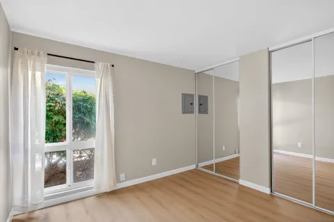 a dining room with furniture and a potted plant