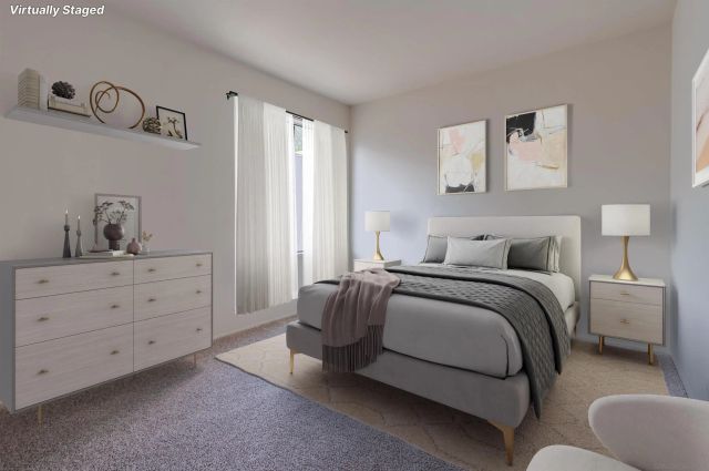 a bedroom with a bed and a dresser