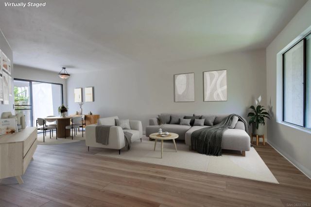 a living room with furniture window and wooden floor