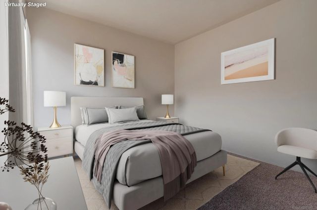 a bedroom with a bed and a lamp