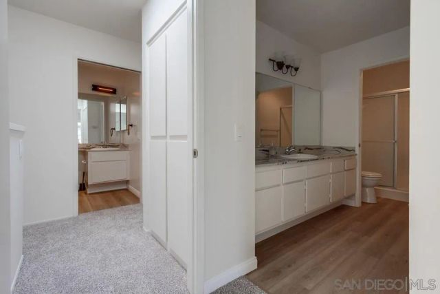 a room view with a hallway and a kitchen