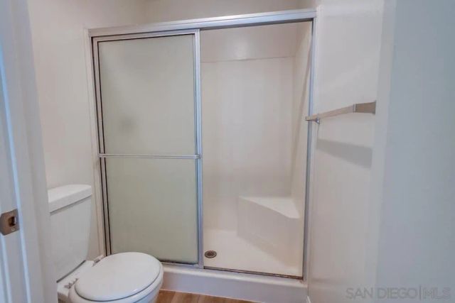 a bathroom with a shower and a toilet