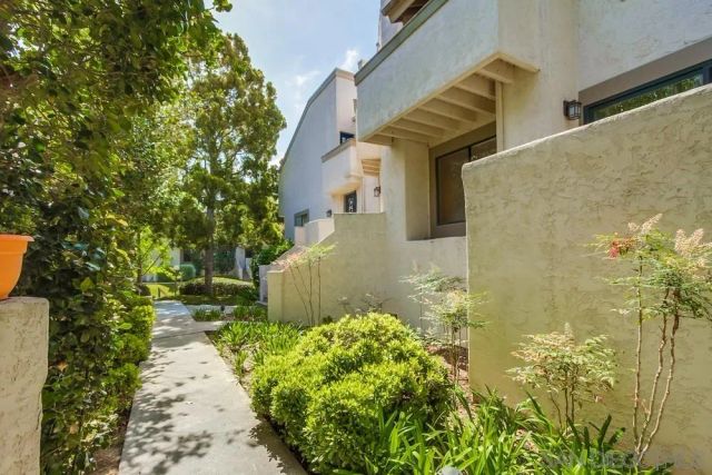 a pathway of a house with a yard