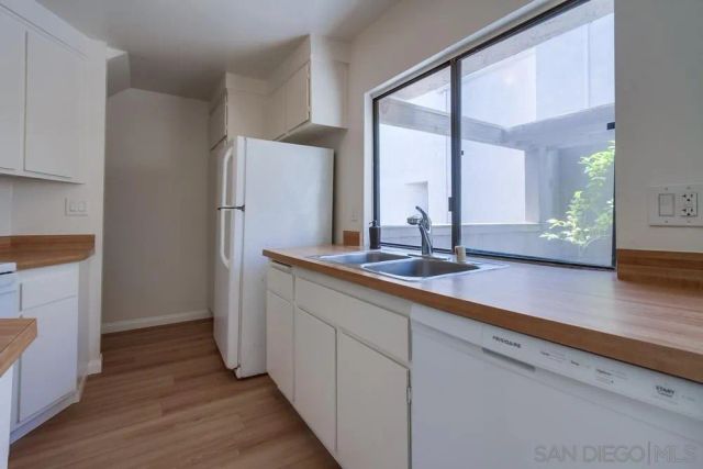 a kitchen with stainless steel appliances a sink and a large window