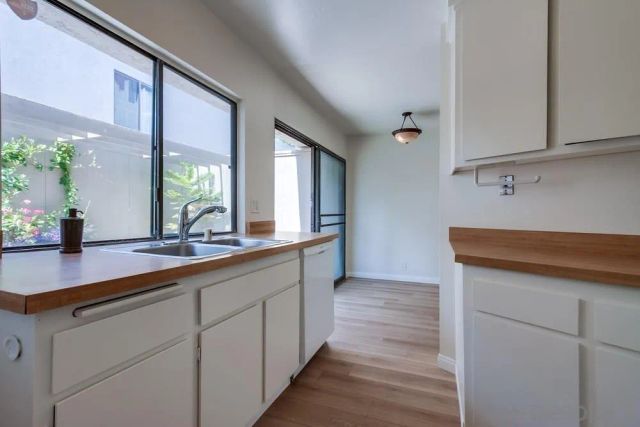 a hallway with sink and mirror
