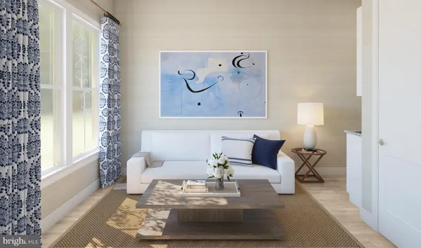 a living room with furniture and a painting