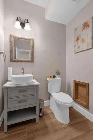 a bathroom with a sink toilet a mirror and vanity