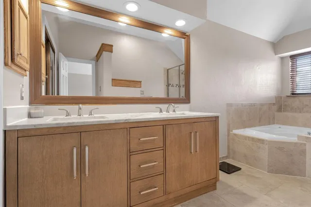 a bathroom with a granite countertop sink a toilet and a mirror