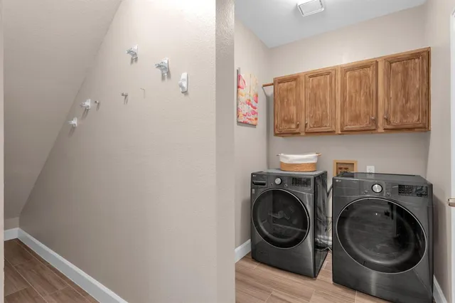 a utility room with sink dryer and washer