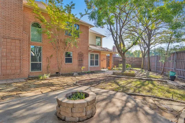 a view of a house with a small yard and sitting area