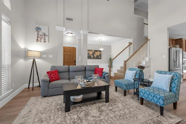 a living room with furniture and wooden floor