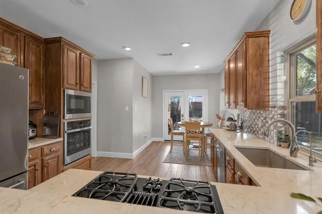 a kitchen with a sink stove and cabinets