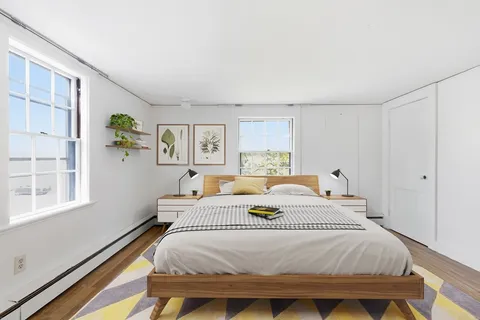 a bedroom with a bed and a window