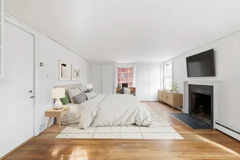 a large white bed in a white room