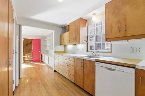 a kitchen with stainless steel appliances granite countertop a stove a sink and a white cabinets