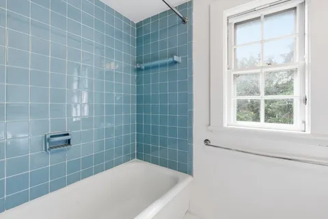 a bath tub sitting next to a window
