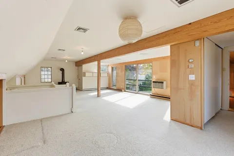 a big room with closet and large windows