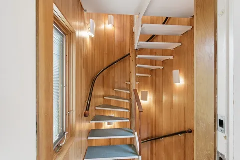 a view of staircase with wooden floor and windows