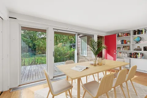 a view of a dining room with furniture window and outside view