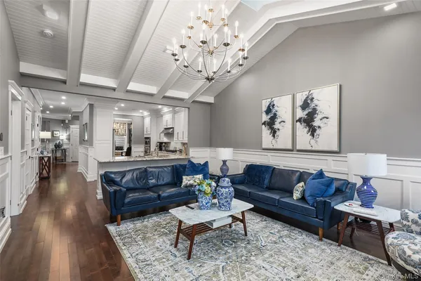 a living room with furniture and a chandelier