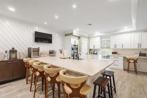a dining room with kitchen island granite countertop furniture and a flat screen tv