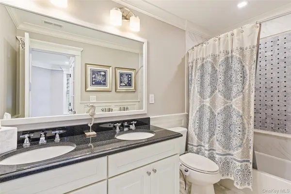 a living room with furniture and floor to ceiling windows